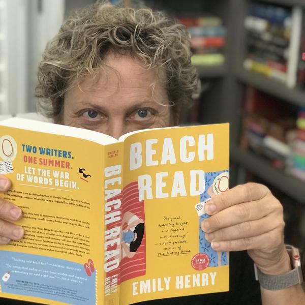 Terry reminding us Books are Essential peeking over  BEACH READS 